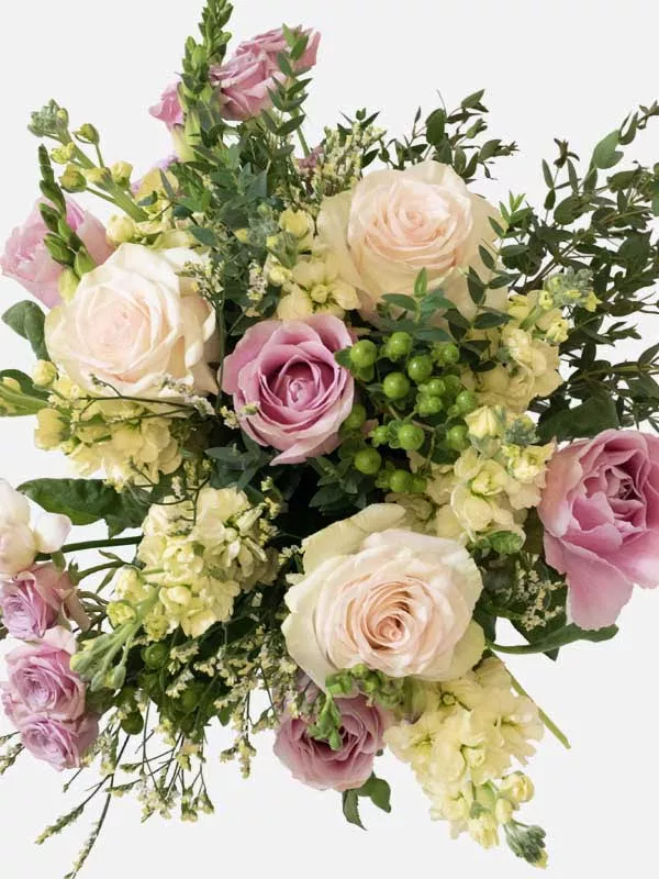 Arial shot of large bouquet of Pink Cupcake Roses, Pink Roses, White Limonium and Pink Spray Roses bouquet photographed from above