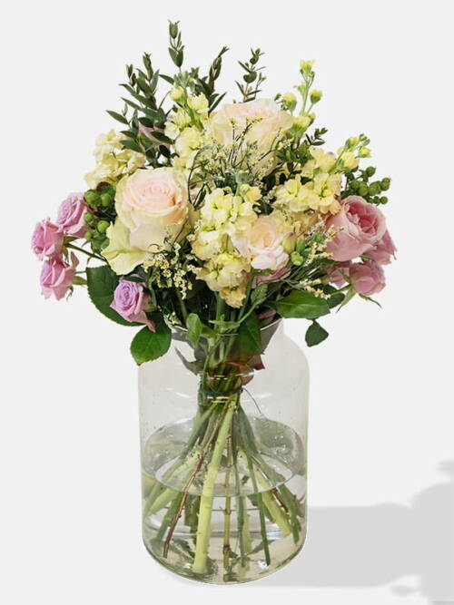 Mixed bouquet of Pink Cupcake Roses, Pink Roses, White Limonium, Pink Freesia, Pink Spray Roses in a vase