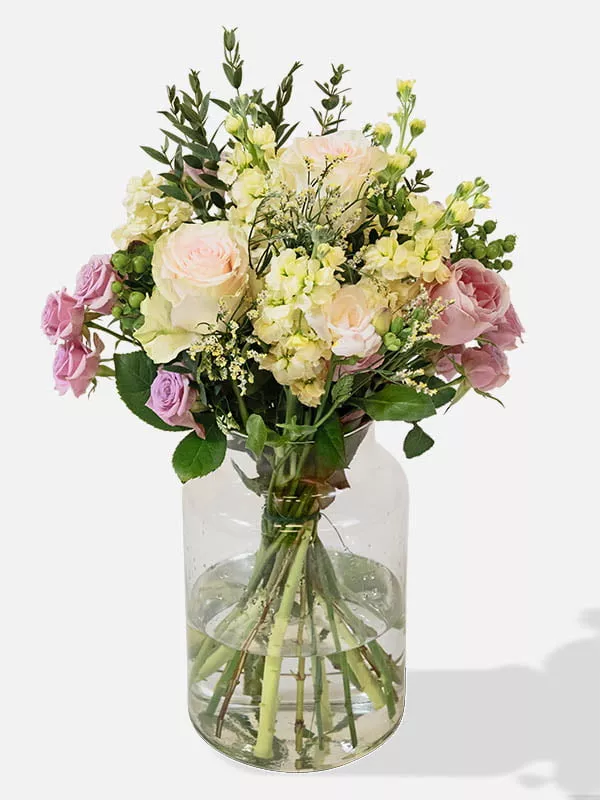Mixed bouquet of Pink Cupcake Roses, Pink Roses, White Limonium, Pink Freesia, Pink Spray Roses in a vase